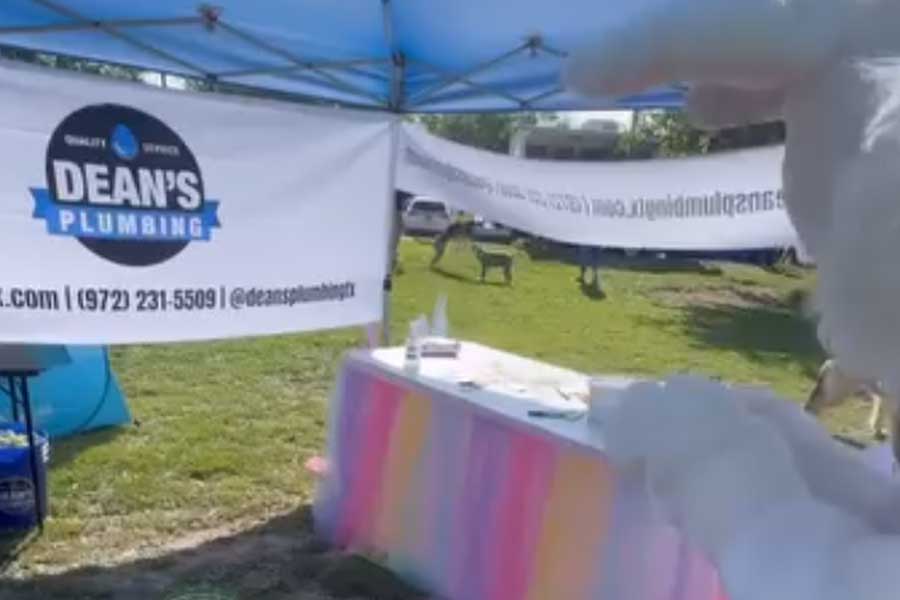 Event tent displaying Dean's Plumbing logo