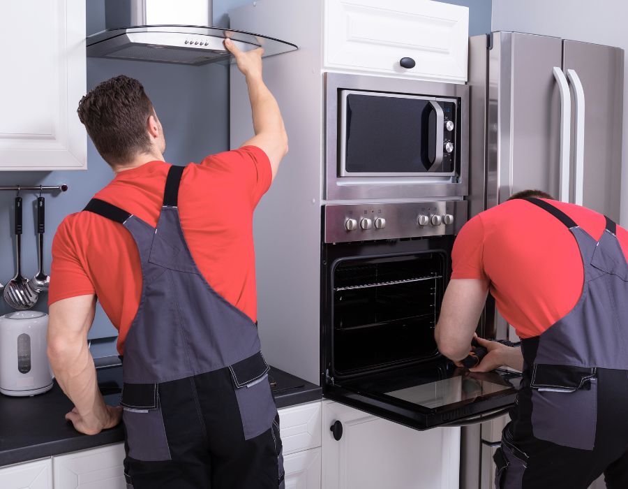 Plumber performing appliance hook-up