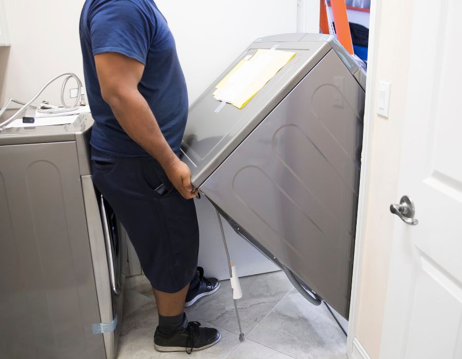 Plumber installing appliance connections