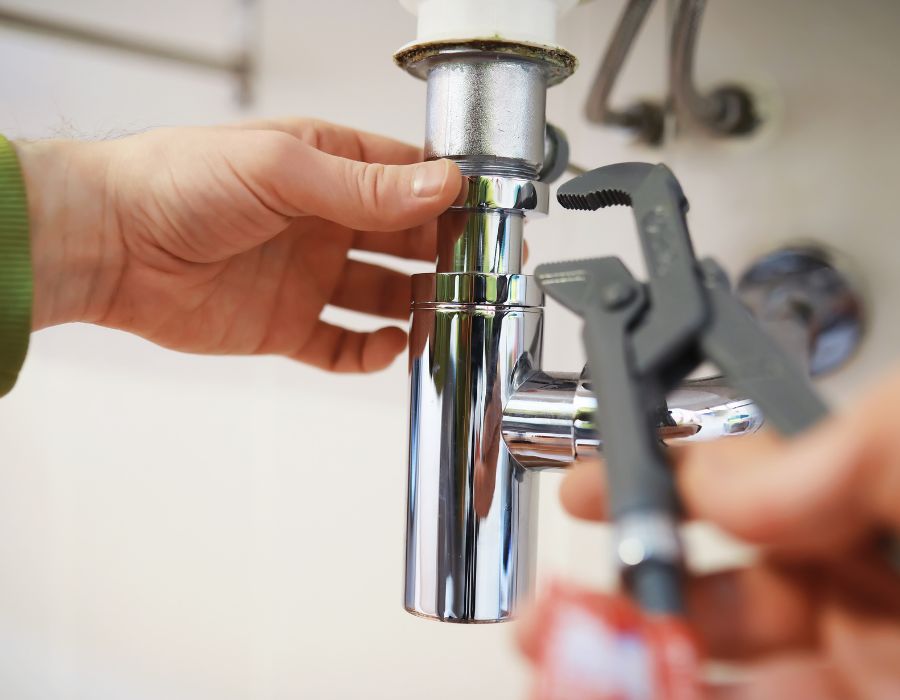 Plumber inspecting pipe