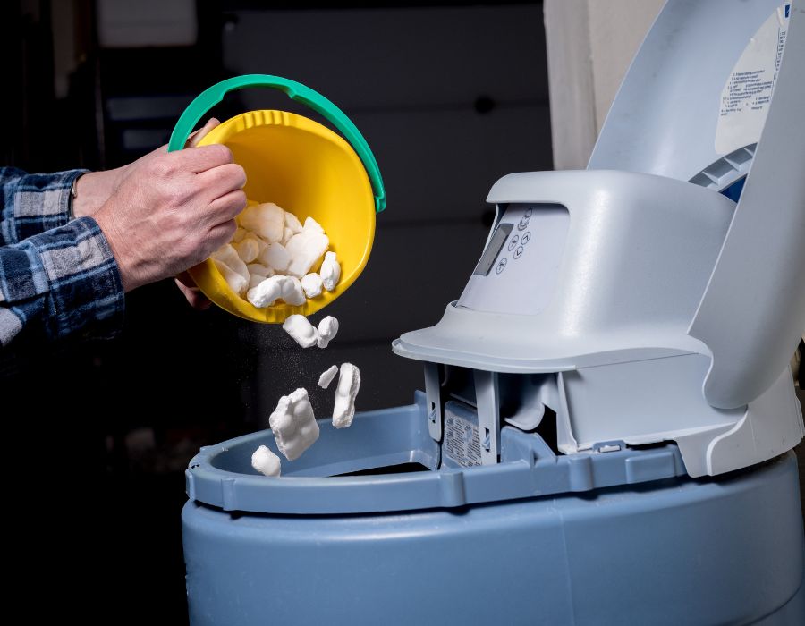 Plumber servicing water softener